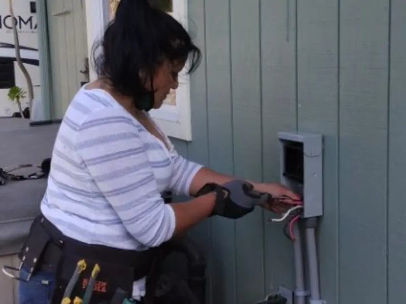 Licensed electrician wiring an exterior subpanel in Grant