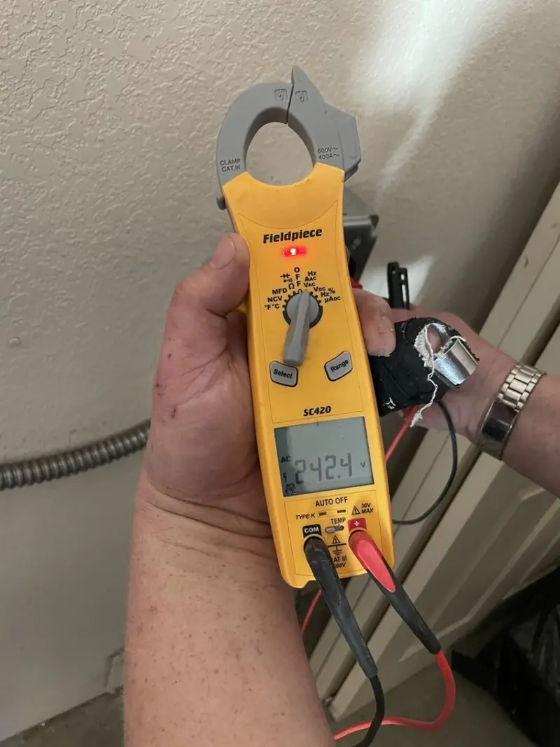 Voltage testing with clamp meter during Outlet Installation in Grant